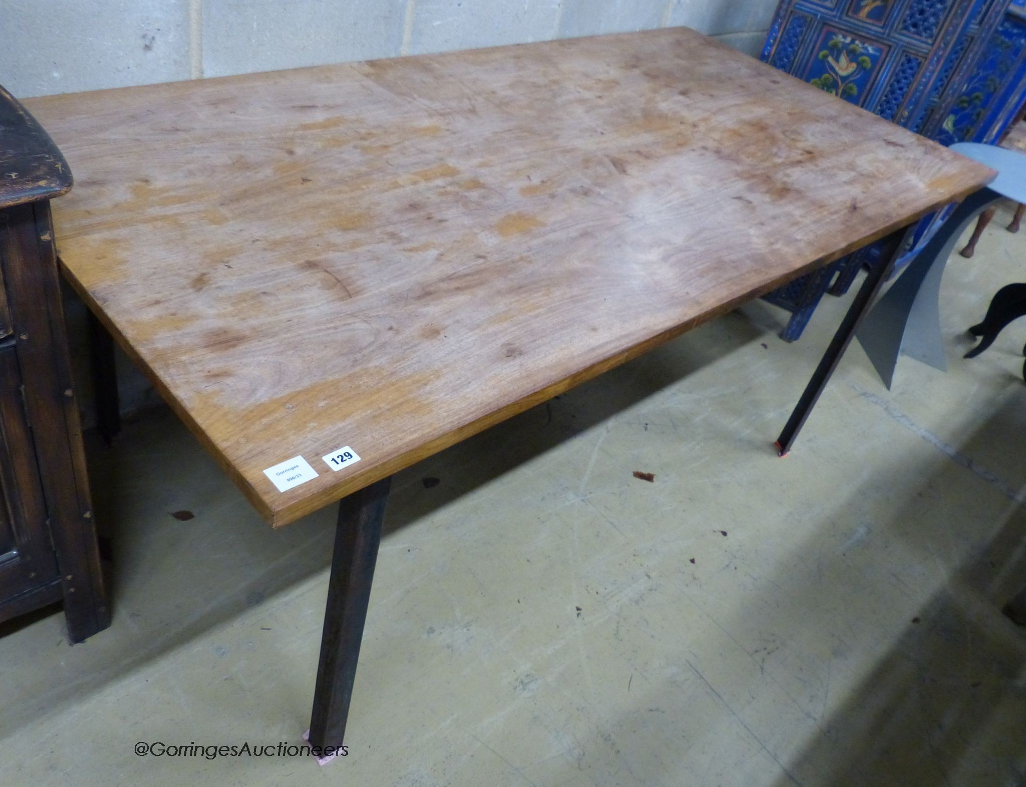 A walnut veneer and steel rectangular dining table, designed and made by Bill Gill, circa 1960, length 185cm, depth 90cm, height 74cm